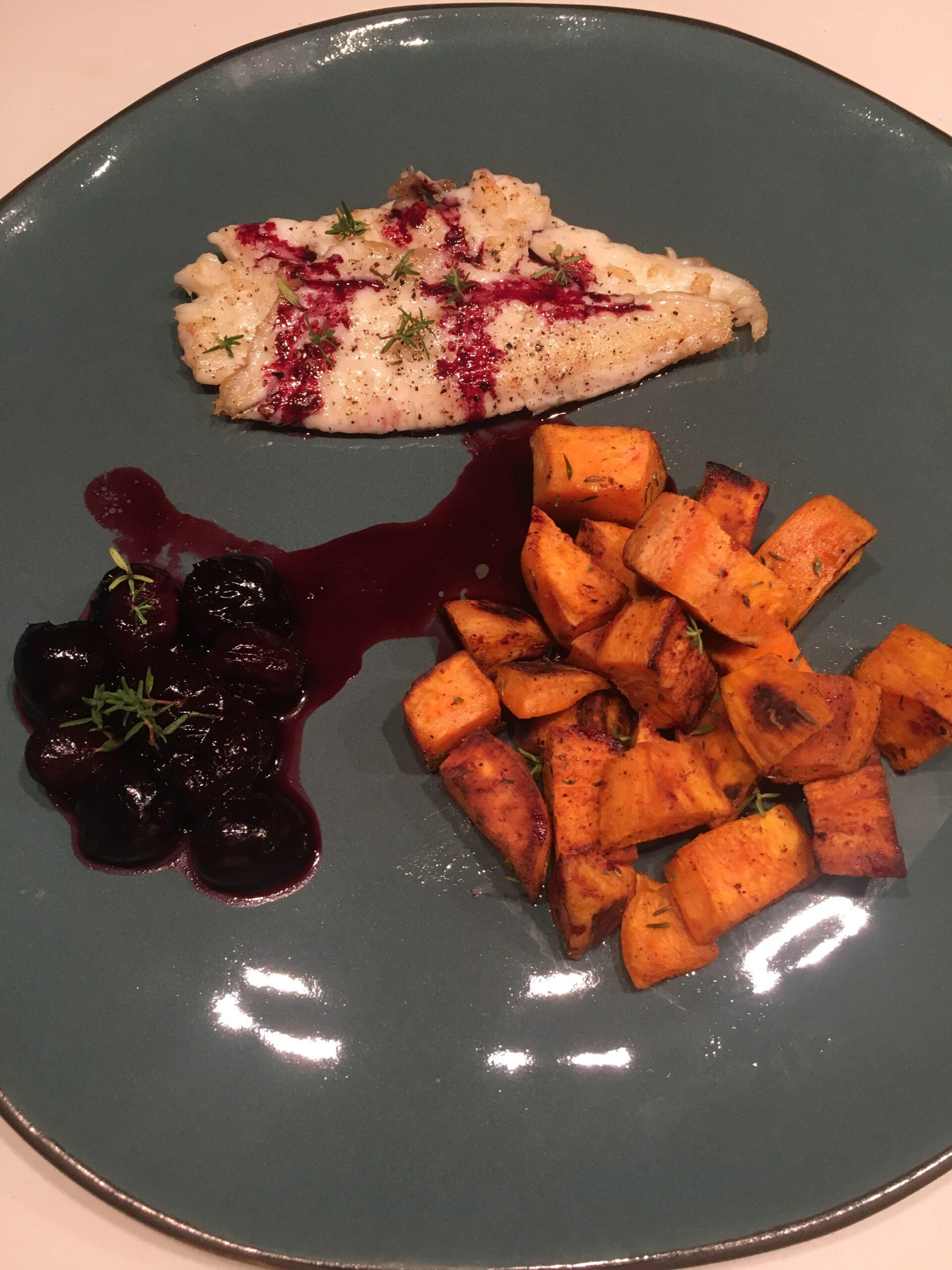 Pan-fried sea bream fillet with roasted sweet potatoes, cherries & thyme
